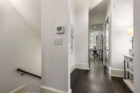 an empty room with wooden floor and entrance