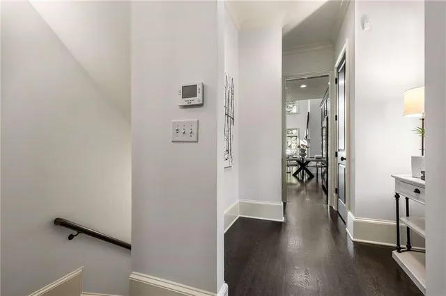 an empty room with wooden floor and entrance