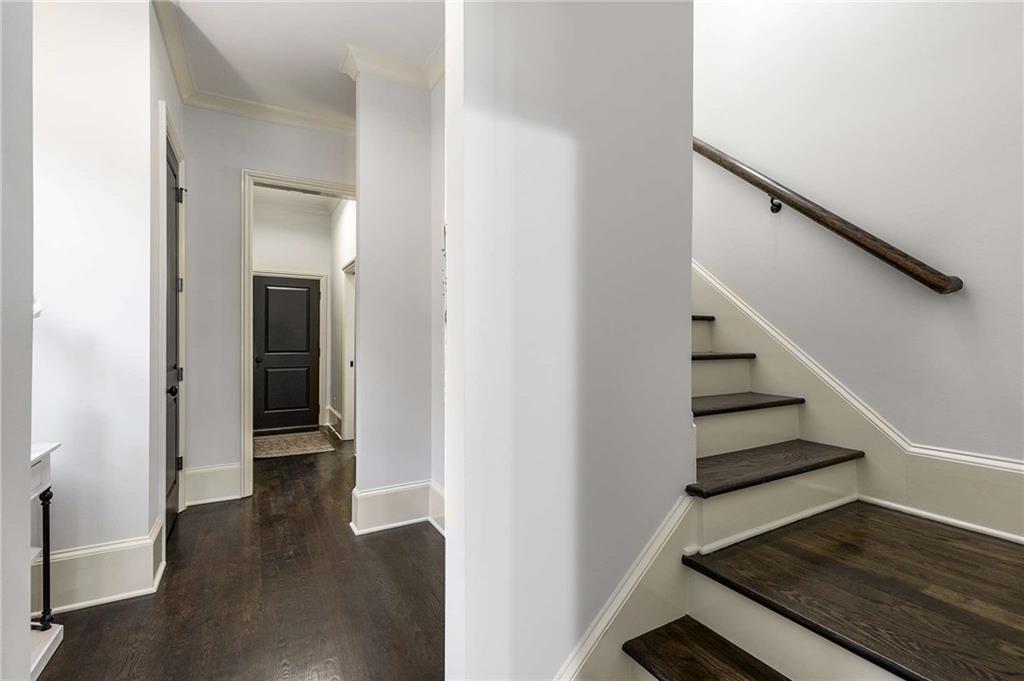 147 Hubbard Road Woodstock, GA 30188 - Photo 39 of 56 a view of a hallway with wooden floor and stairs