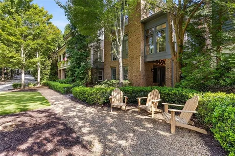 a view of a brick building next to a yard