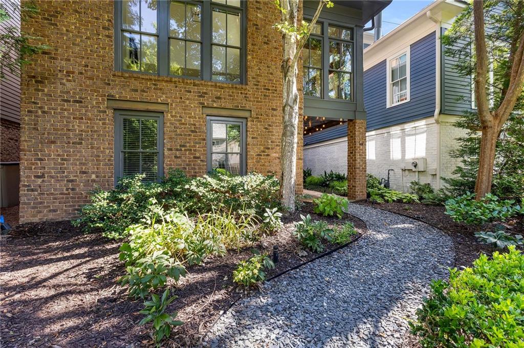 147 Hubbard Road Woodstock, GA 30188 - Photo 6 of 56 a view of a brick building next to a yard