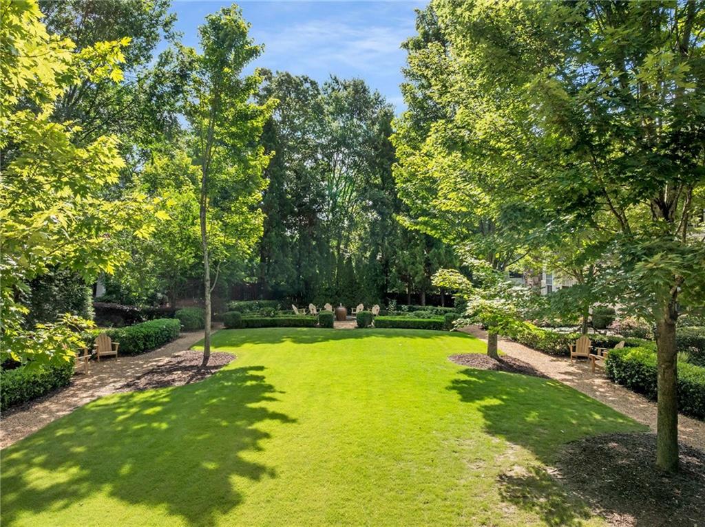 147 Hubbard Road Woodstock, GA 30188 - Photo 7 of 56 a view of a swimming pool with a yard and large trees