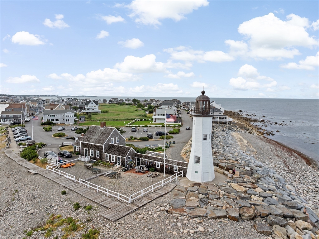 89 Lighthouse Road Scituate, MA 02066 - Photo 39 of 42 an aerial view of a building with table and chairs