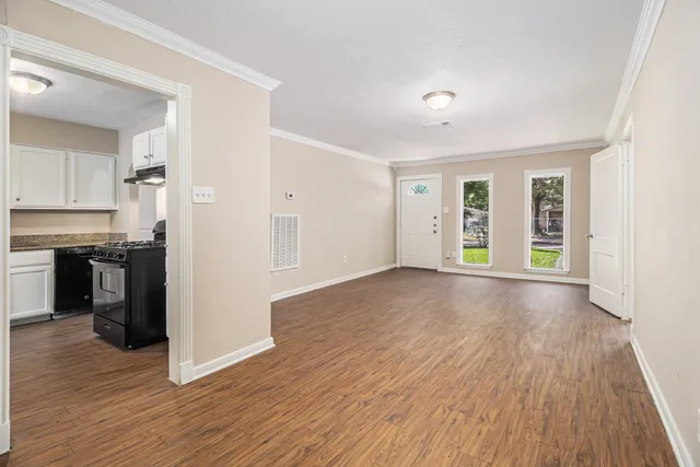 a view of a kitchen with wooden floor and a sink