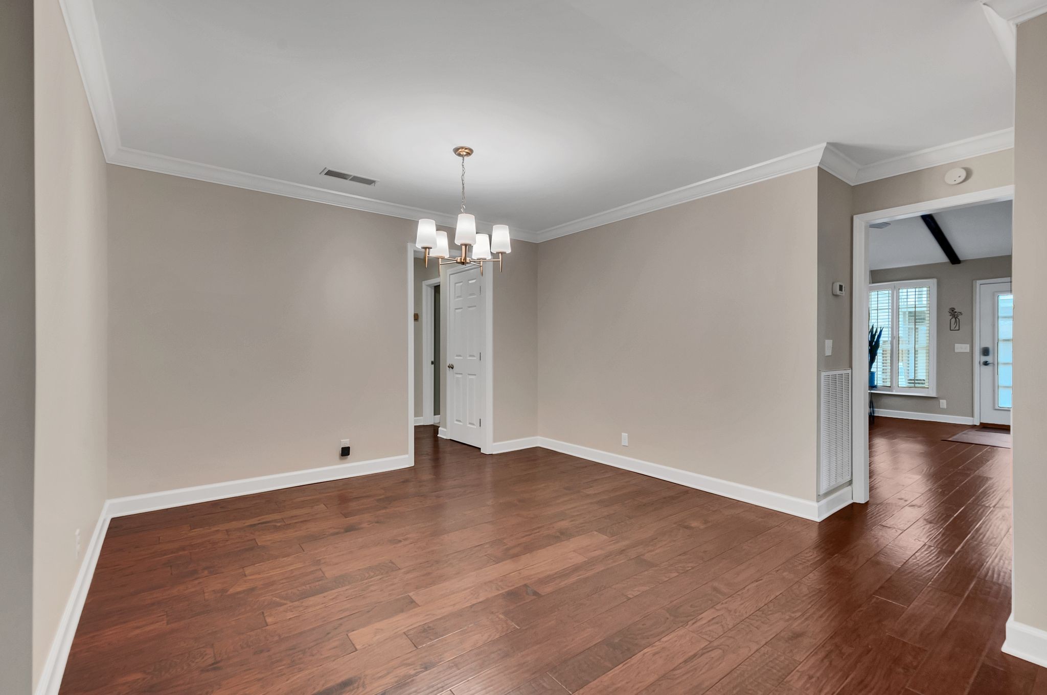 1343 General George Patton Road Nashville, TN 37221 - Photo 12 of 41 an empty room with wooden floor and chandelier