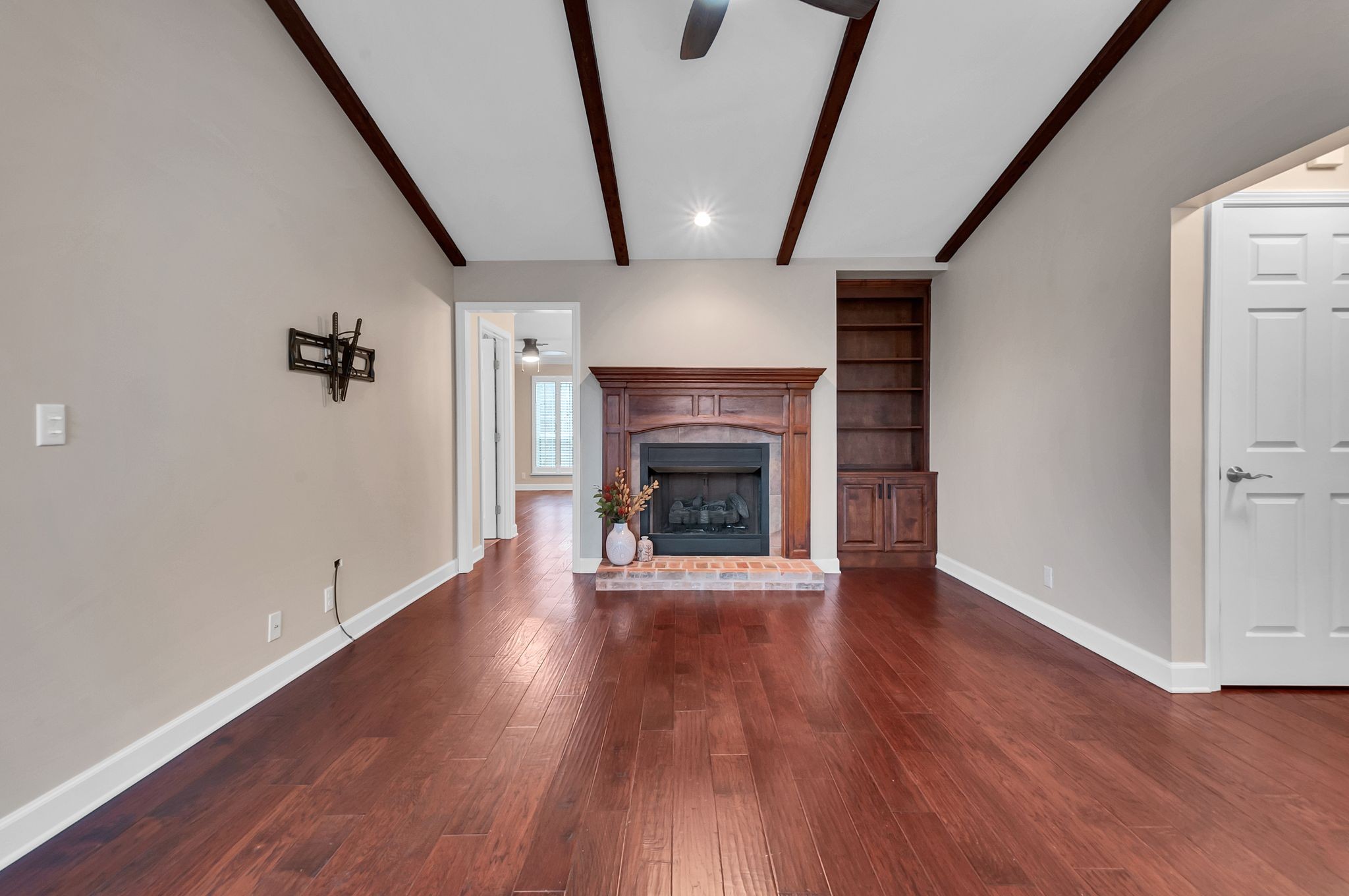 1343 General George Patton Road Nashville, TN 37221 - Photo 18 of 41 an empty room with wooden floor and fireplace