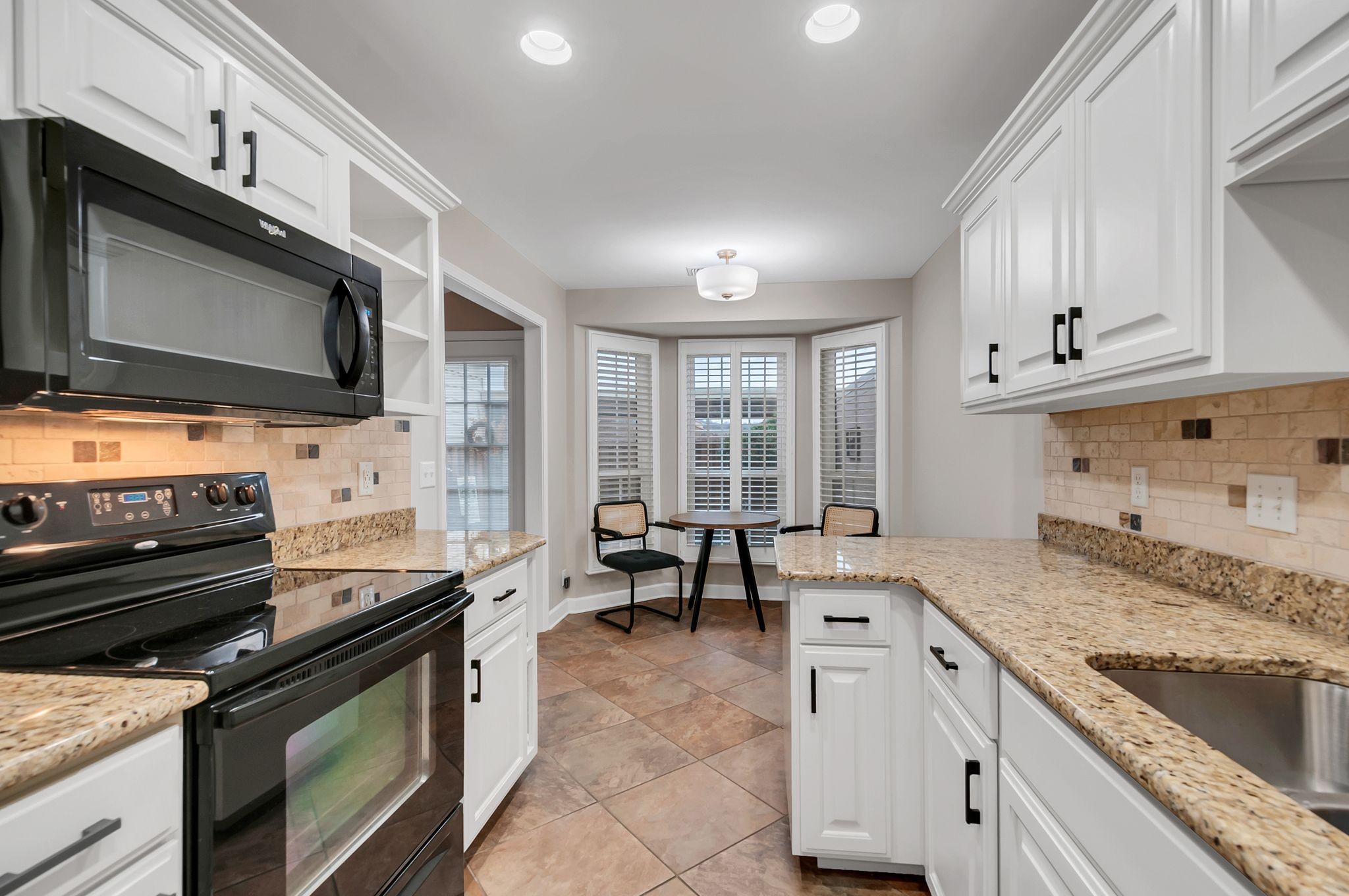 1343 General George Patton Road Nashville, TN 37221 - Photo 23 of 41 a kitchen with stainless steel appliances granite countertop a stove and a microwave