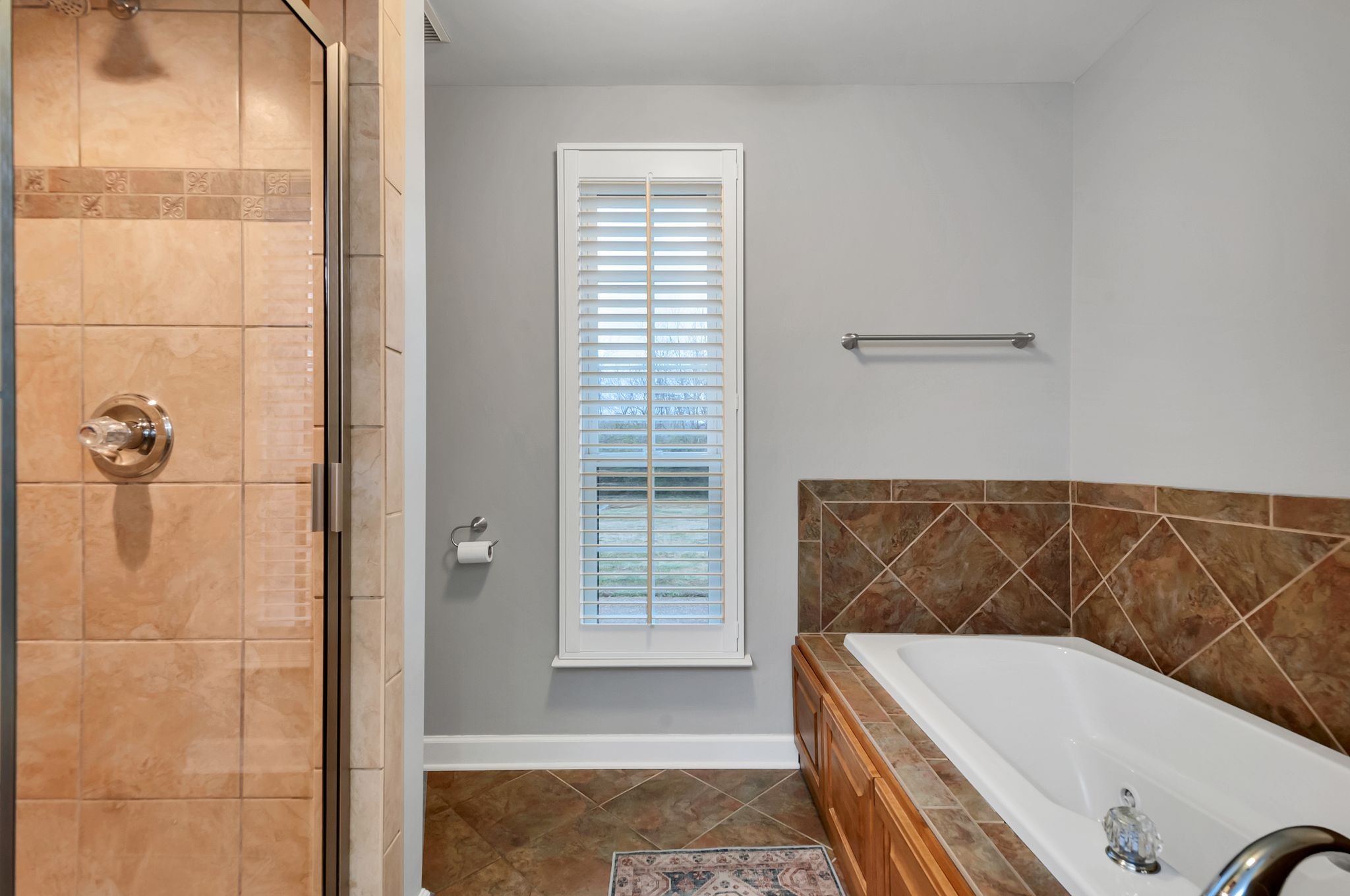 1343 General George Patton Road Nashville, TN 37221 - Photo 28 of 41 a bathroom with a tub a window and shower