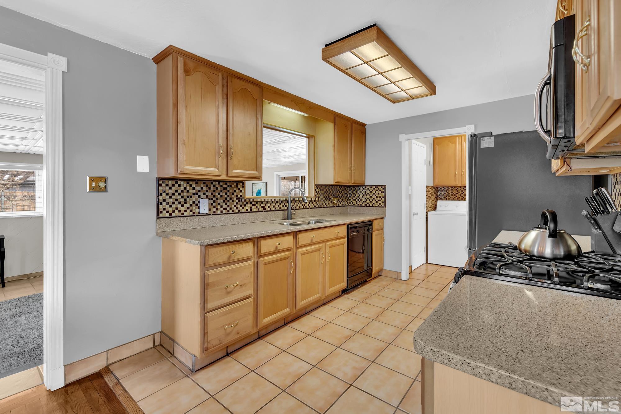 1830 West 7th Street Reno, NV 89503 - Photo 12 of 36 a kitchen with a stove a sink and a refrigerator