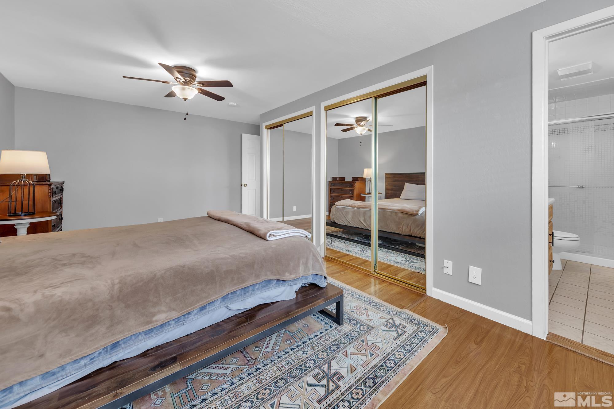 1830 West 7th Street Reno, NV 89503 - Photo 22 of 36 a bedroom with a bed and a view of en suite bathroom