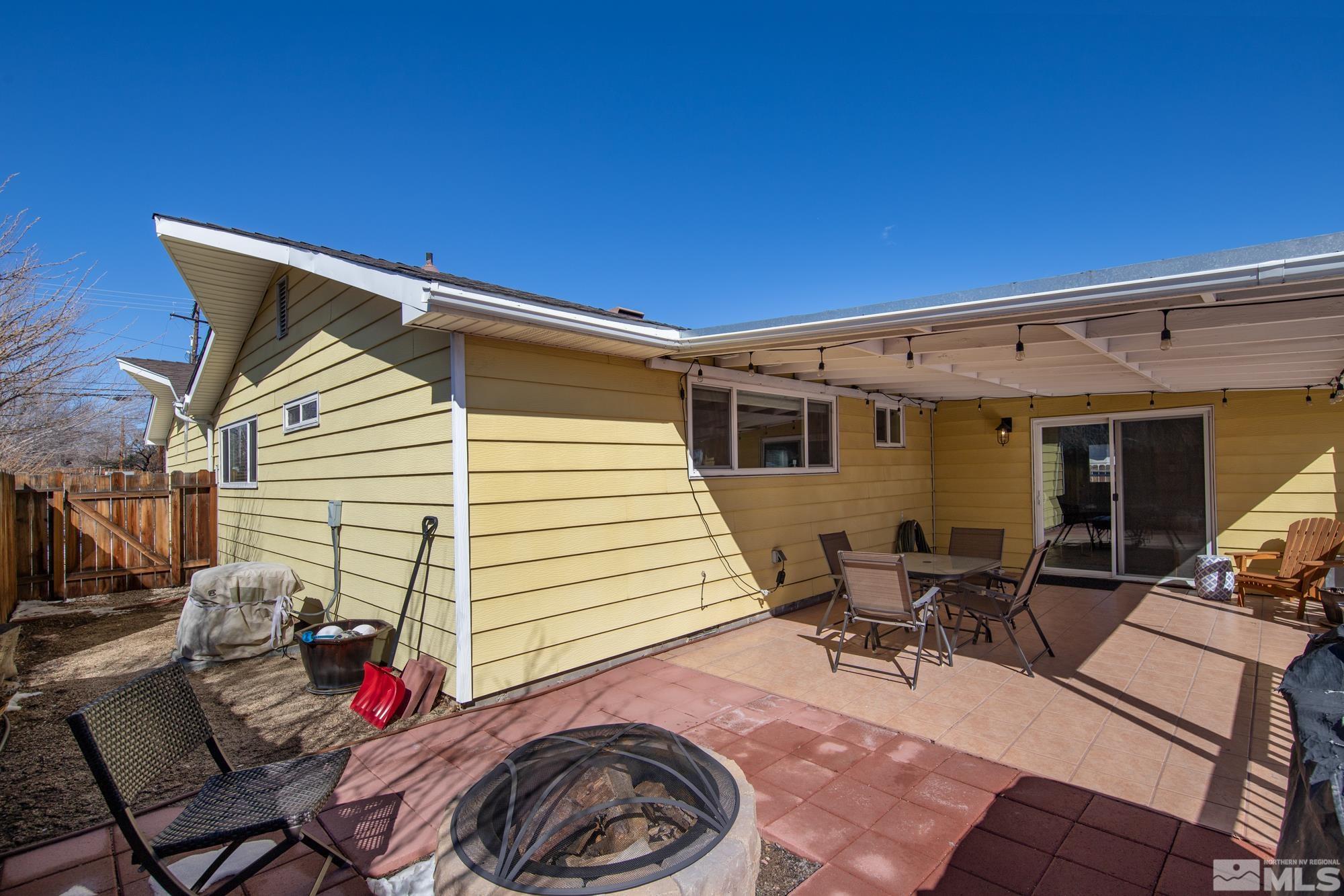 1830 West 7th Street Reno, NV 89503 - Photo 34 of 36 a view of a patio with table and chairs with wooden fence