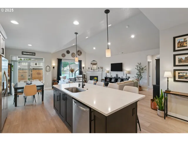 a view of a dining room and livingroom with furniture wooden floor a flat screen tv