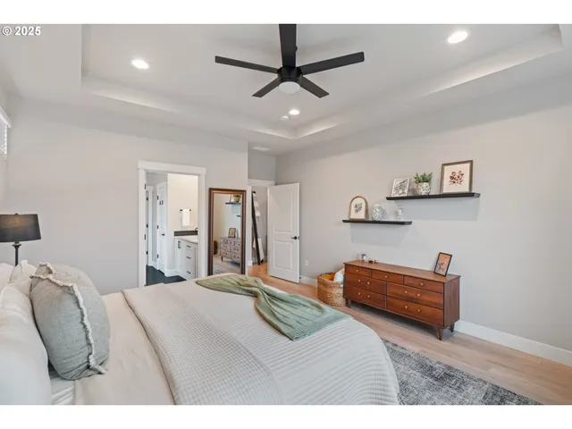 a bedroom with a bed and a ceiling fan