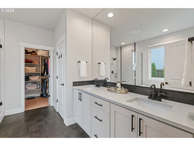 a bathroom with a double vanity sink and mirror