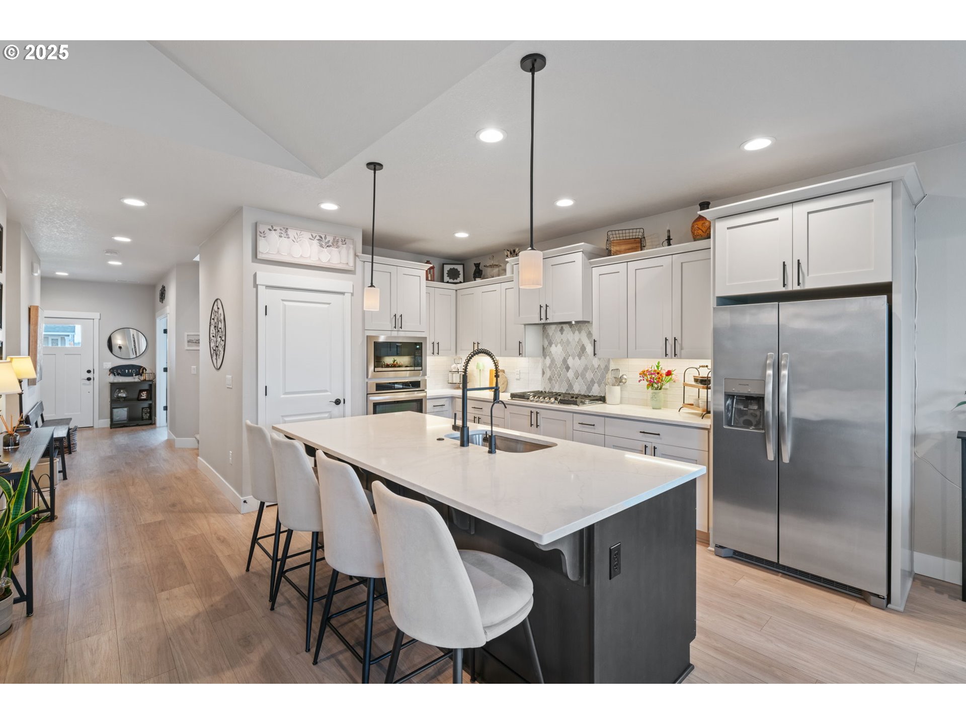 8842 North 3rd Circle Ridgefield, WA 98642 - Photo 3 of 46 a kitchen with stainless steel appliances kitchen island granite countertop a refrigerator a sink and a stove