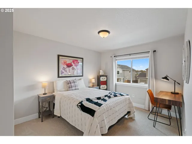 a bedroom with a bed and a table in it