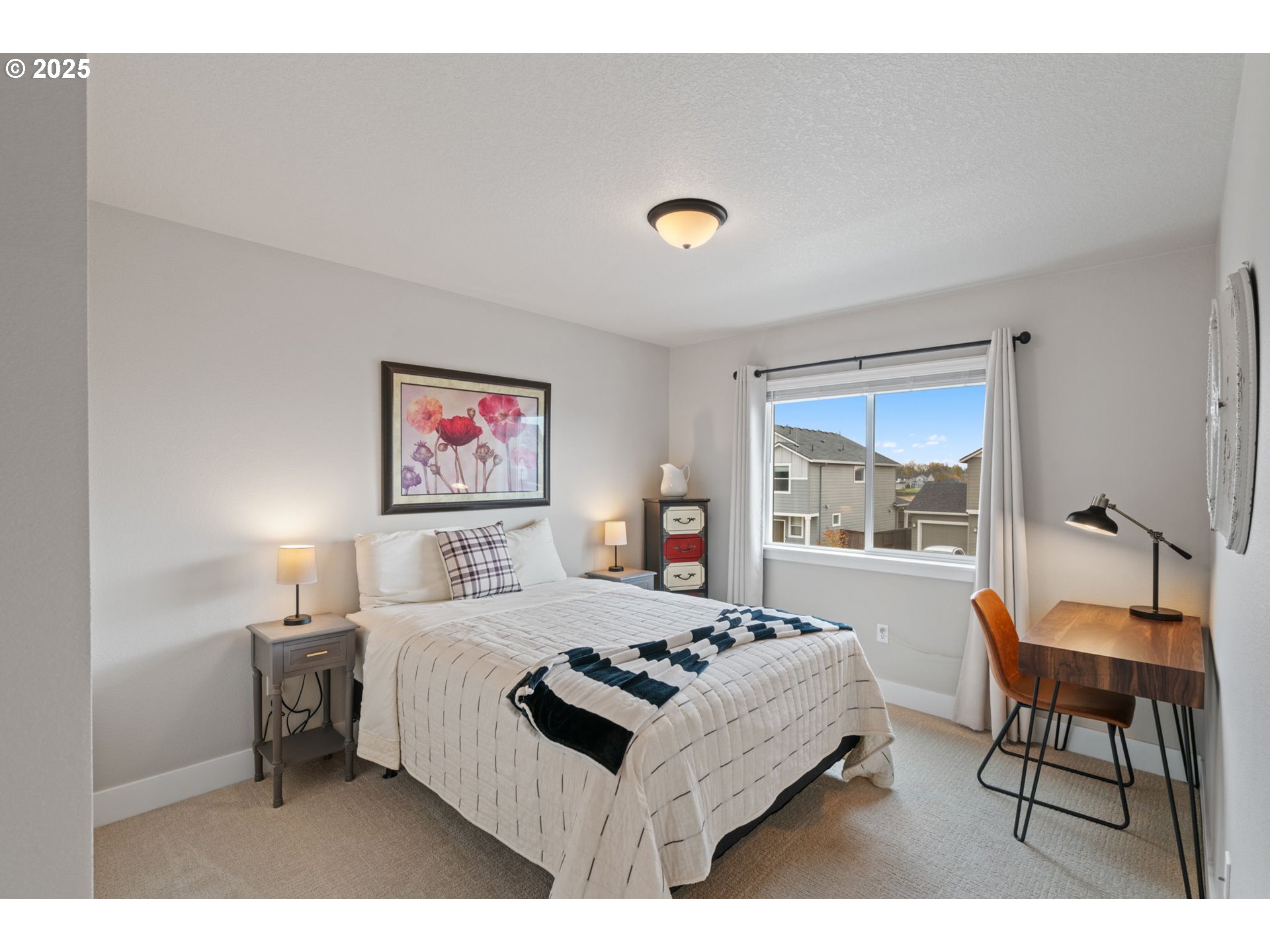 8842 North 3rd Circle Ridgefield, WA 98642 - Photo 35 of 46 a bedroom with a bed and a table in it