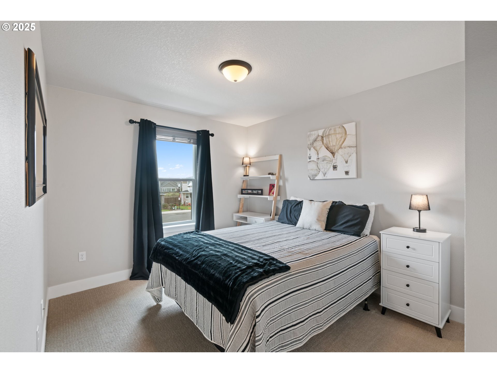 8842 North 3rd Circle Ridgefield, WA 98642 - Photo 36 of 46 a bedroom with a bed and a window