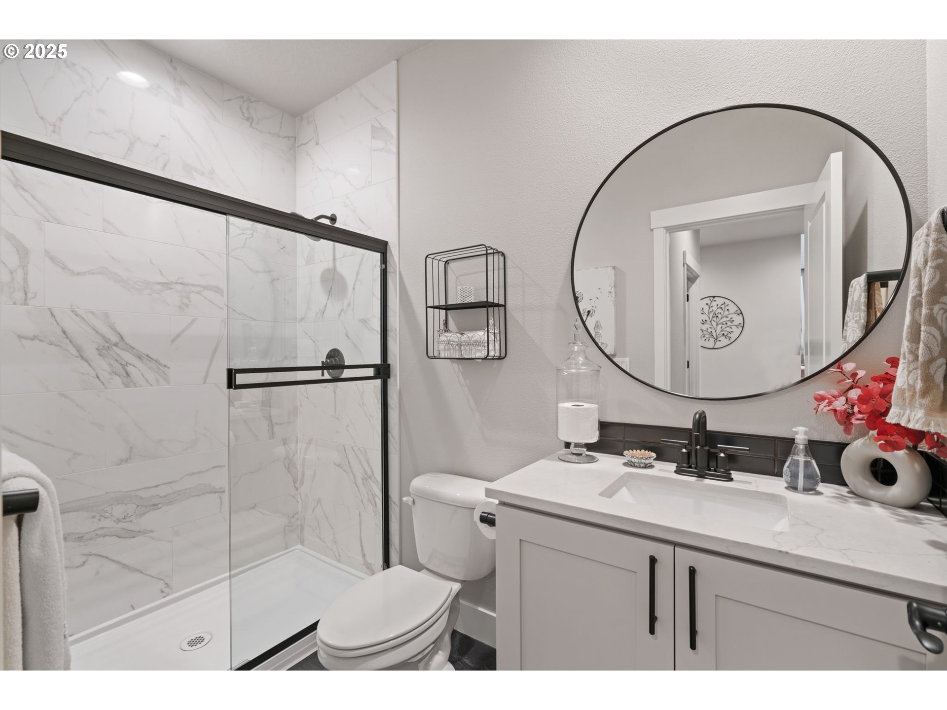 8842 North 3rd Circle Ridgefield, WA 98642 - Photo 37 of 46 a bathroom with a sink mirror and a shower