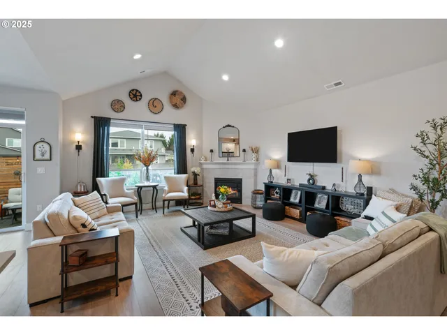 a living room with furniture a fireplace and a flat screen tv