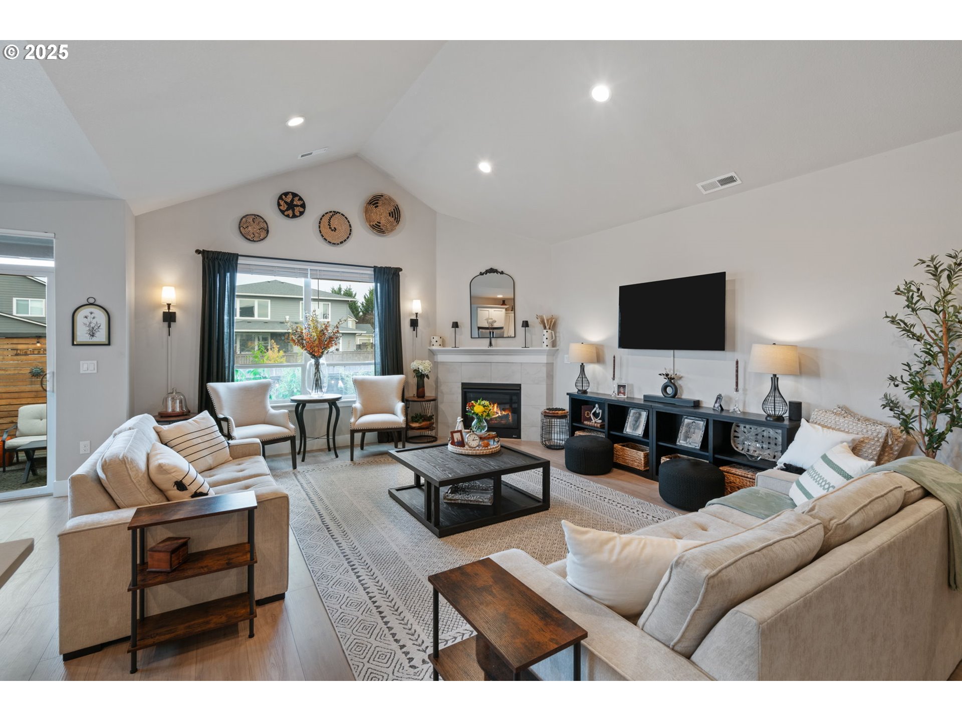8842 North 3rd Circle Ridgefield, WA 98642 - Photo 4 of 46 a living room with furniture a fireplace and a flat screen tv
