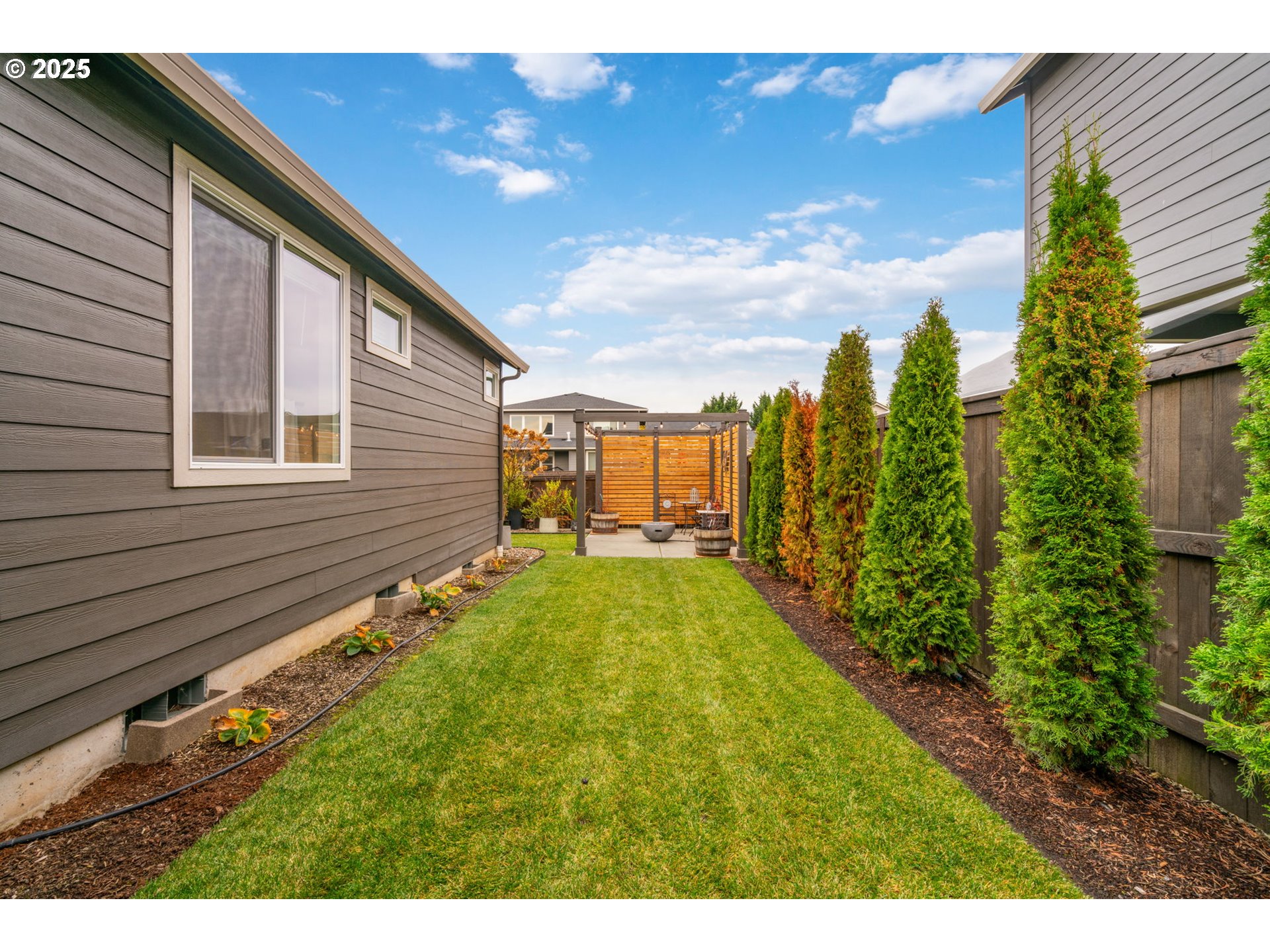 8842 North 3rd Circle Ridgefield, WA 98642 - Photo 44 of 46 a view of a backyard with plants and a garden