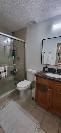 a spacious bathroom with a toilet a sink and shower