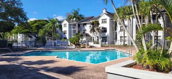 a view of a house with swimming pool and sitting area