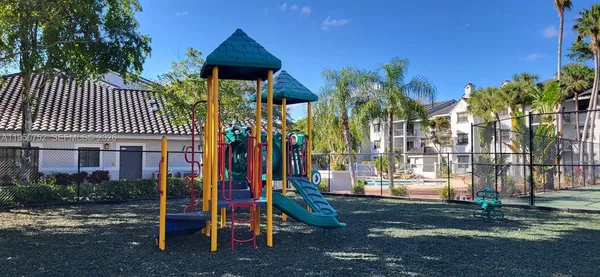 a view of a yard with plants and trees