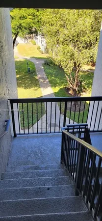 a view of stairs from a balcony