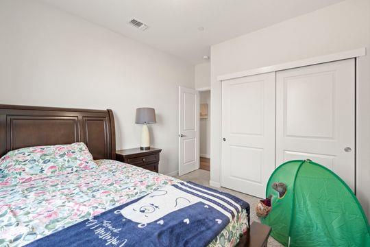 912 Loon Street Lathrop, CA 95330 - Photo 13 of 27 a bedroom with a bed and a dresser