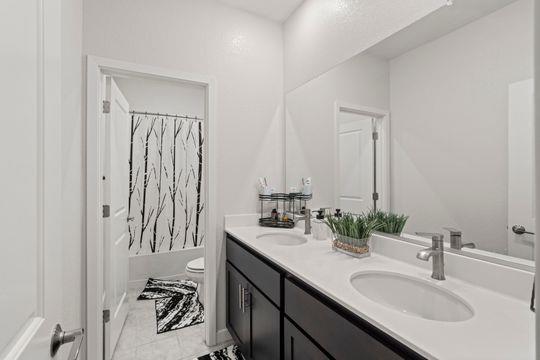912 Loon Street Lathrop, CA 95330 - Photo 16 of 27 a bathroom with a sink and a mirror