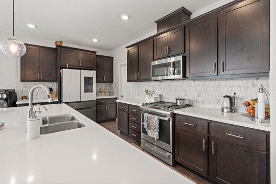 912 Loon Street Lathrop, CA 95330 - Photo 25 of 27 a kitchen with stainless steel appliances granite countertop a sink stove and refrigerator
