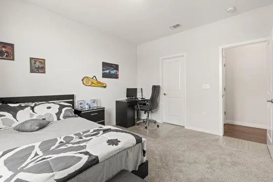 a bedroom with a bed and a table in it