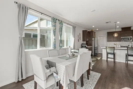 a view of a dining room with furniture window and wooden floor
