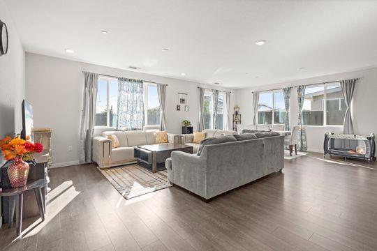 912 Loon Street Lathrop, CA 95330 - Photo 9 of 27 a living room with furniture floor to ceiling window and wooden floor