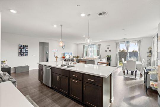 912 Loon Street Lathrop, CA 95330 - Photo 10 of 27 a large white kitchen with a large window and stainless steel appliances