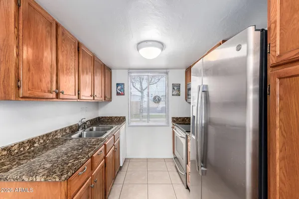 a kitchen with a refrigerator a stove and cabinets