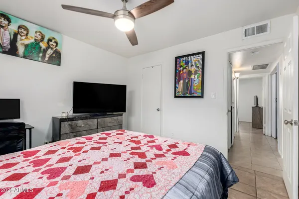 a bedroom with a bed and a flat screen tv
