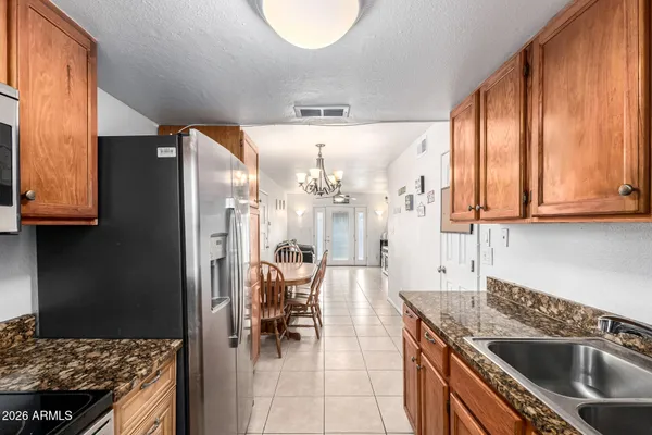a kitchen with stainless steel appliances granite countertop a sink stove and refrigerator