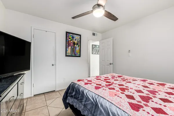 a bedroom with a bed and a flat screen tv