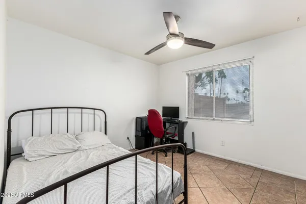 a bedroom with furniture and a window