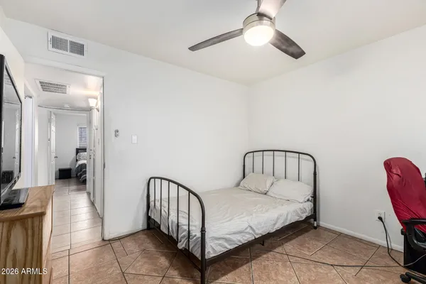 a bedroom with a bed and a chandelier