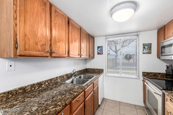 a kitchen that has a sink and a stove