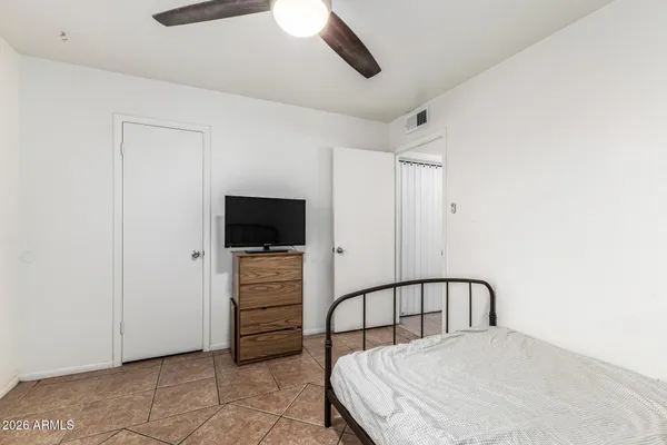 a bedroom with a bed and a view of bathroom