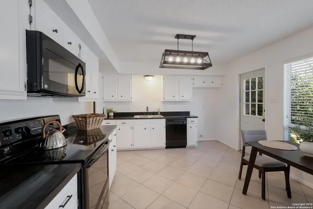 a kitchen with a stove cabinets and microwave