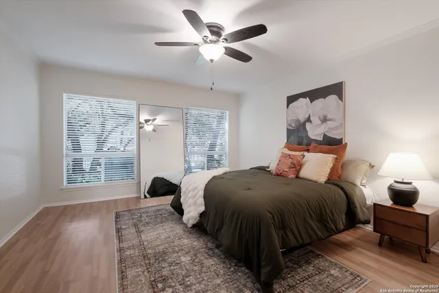 a bedroom with a bed and wooden floor