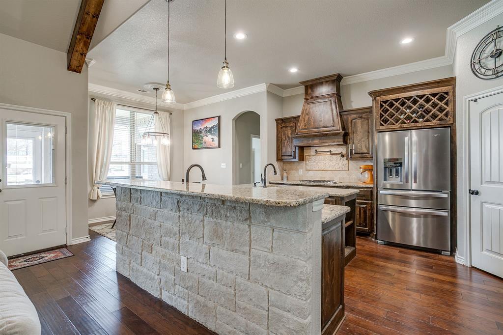 1615 Sanger Drive Springtown, TX 76082 - Photo 11 of 40 a kitchen with stainless steel appliances granite countertop a refrigerator a sink dishwasher a stove and white countertops with wooden floor