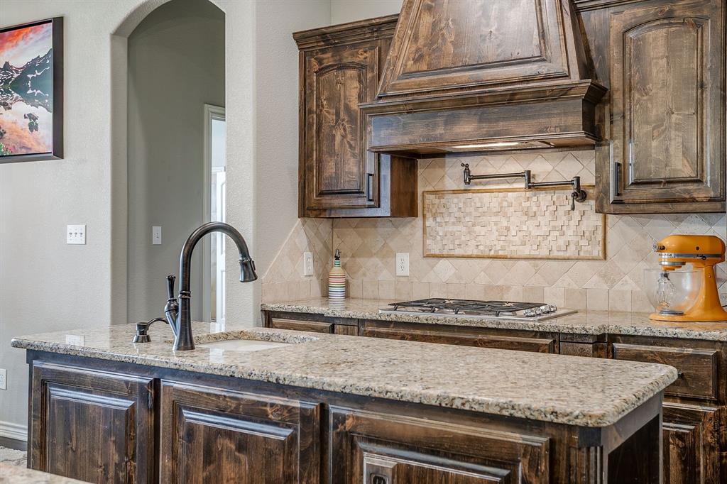 1615 Sanger Drive Springtown, TX 76082 - Photo 12 of 40 a kitchen with granite countertop a sink and cabinets