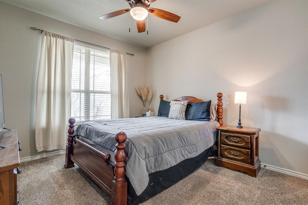 1615 Sanger Drive Springtown, TX 76082 - Photo 23 of 40 a bed sitting in a bedroom next to a window